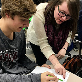 Ms. Schriro works with student in math class