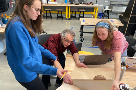 Two students work on a project in the Rhodos makers space with Dr. Simon Tarr