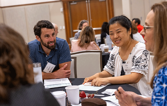 Faculty members have a discussion at the 2024 Propel AI kickoff.