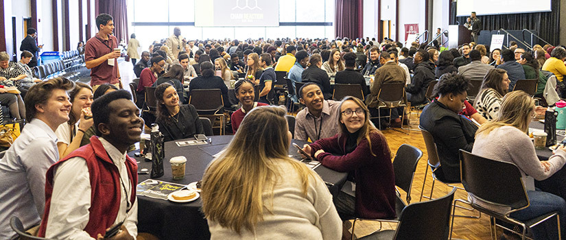 Students watch a presentation in a packed Russell House ballroom.