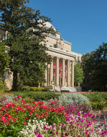 The front of McKissick Museum with large banners with the tailfeathers.