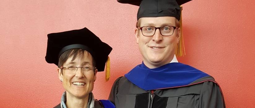 man and woman in cap and gown