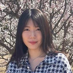 woman with dark hair and blue and white checked shirt on