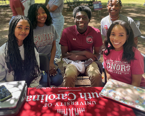 A group of young black students smiling.