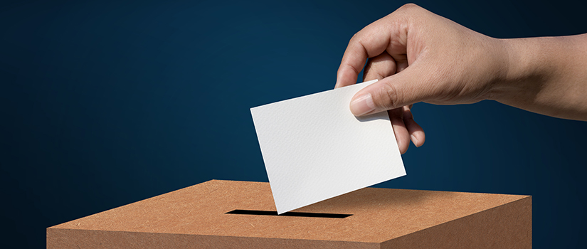 Hand placing an envelope in a box