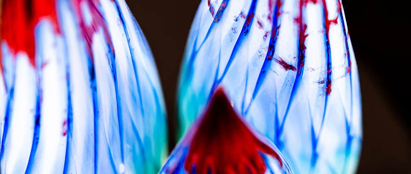 Close-up view of an abstract glass award featuring blue, red and white crystal elements, symbolizing visionary leadership, creativity and innovation.