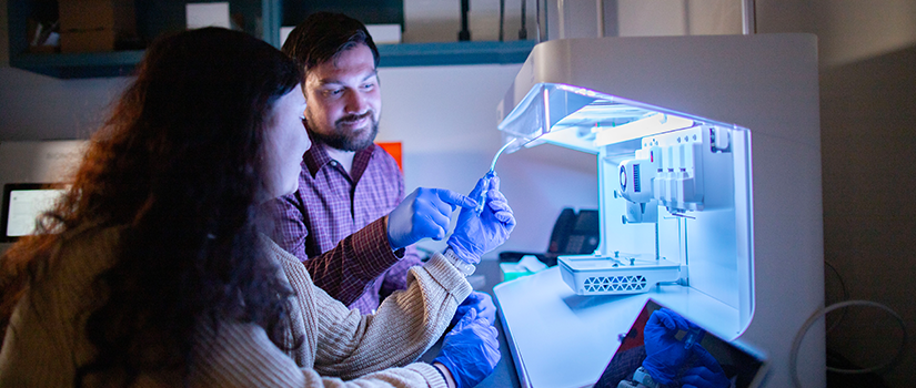 Instrumentation Resource Facility Director Austin Worden, Ph.D. and his research assistant working on a bioprinter.