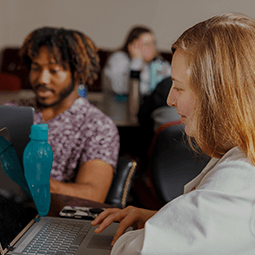 Two students at laptops