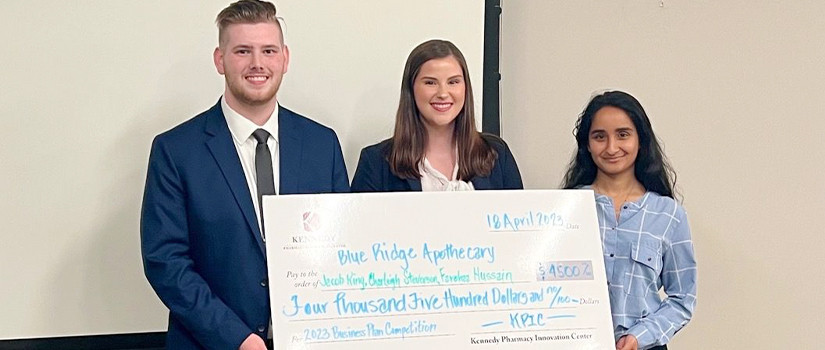 Students holding oversized check