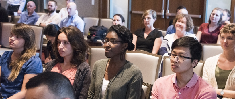 Group of students in an auditorium paying attention to a lecture