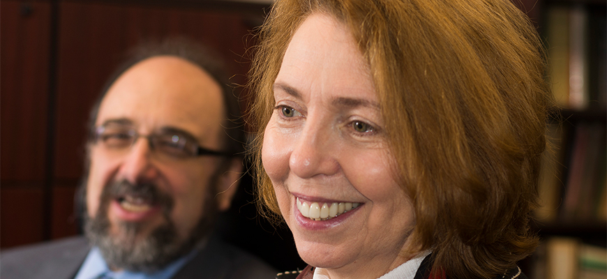 Dr. Eugenia Broude smiles while meeting with other faculty members. 