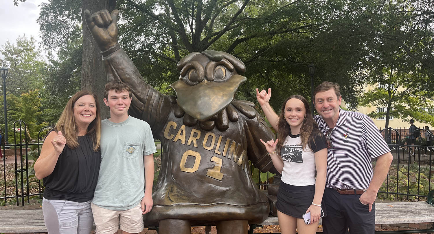 Amy and her family pose with statue of USC mascot, Cocky