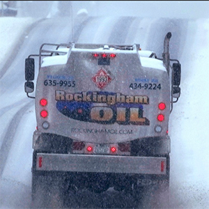 A truck transports heating oil through snow