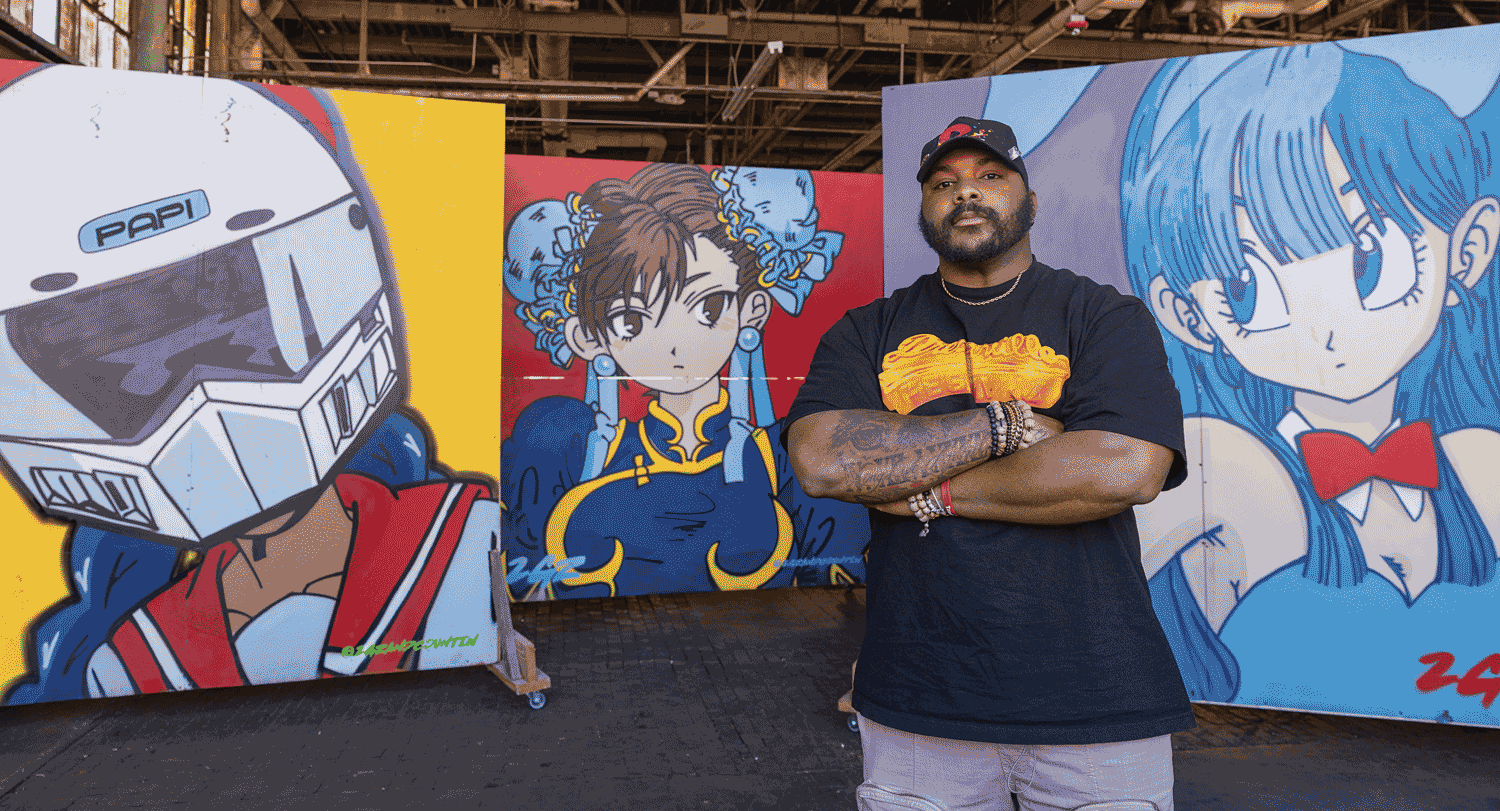 Garrison Gist stands in front of three movable wall murals in his studio at Charlotte’s Camp North End