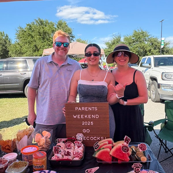 Photo of three people at a tailgate party outside Williams-Brice stadium
